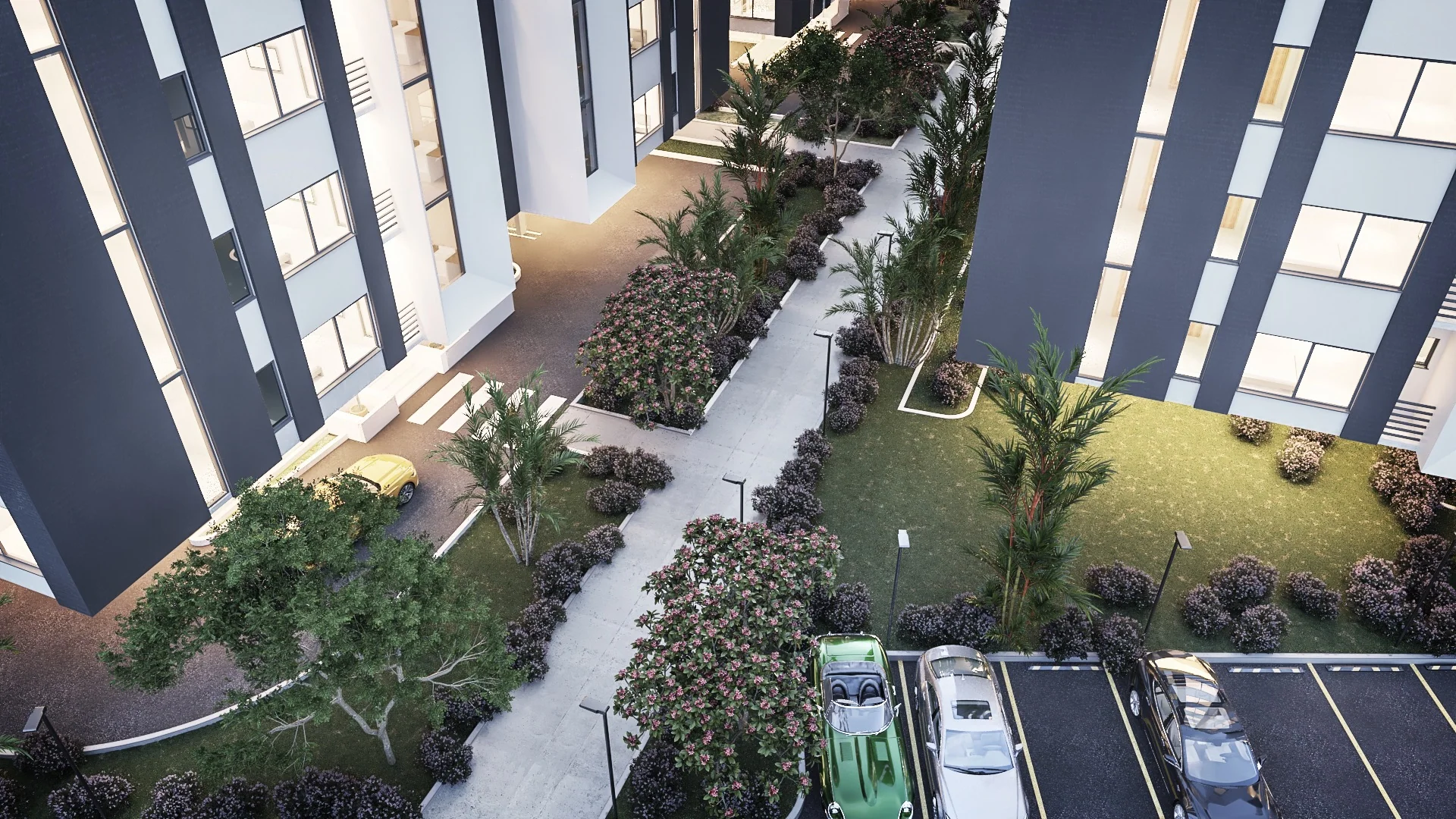 An aerial view of apartment blocks around a landscaped courtyard with a paved path, lawn and parking