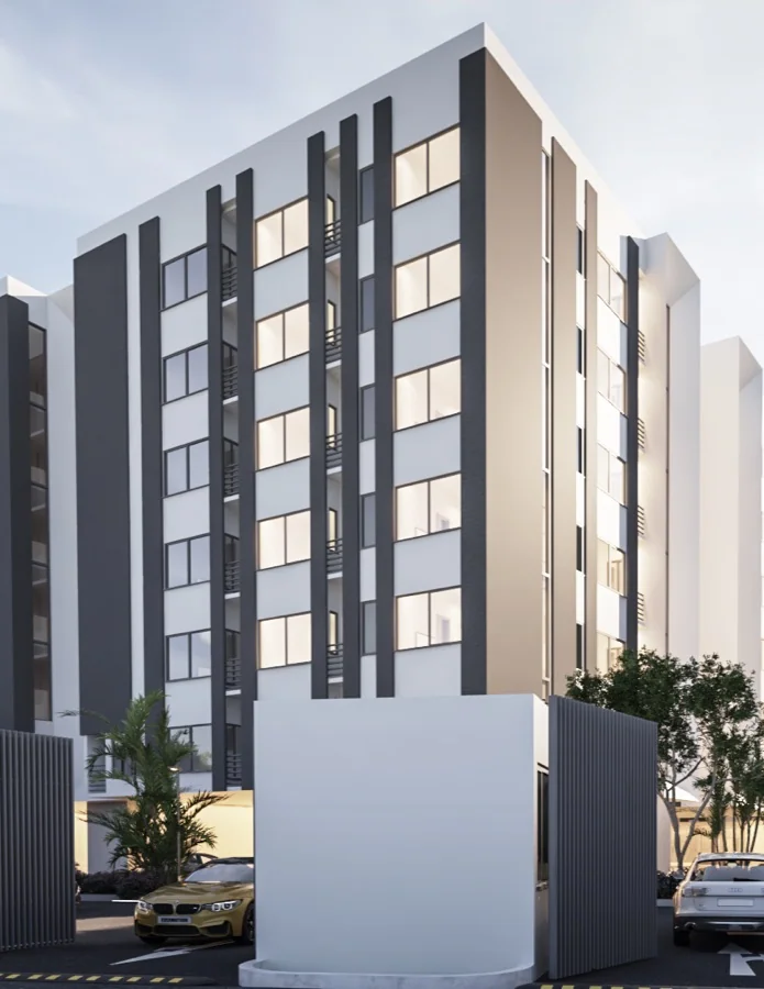 A six-storey apartment block with charcoal fins and white balconies, seen from the street